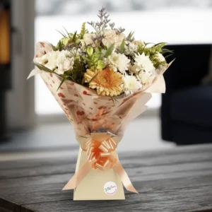 Pastel Petals Bouquet with peach gerberas and white flowers in a gift box on a wooden table, hand-delivered in Chester.