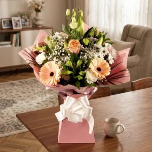 Petal Promise Bouquet featuring peach gerberas, cream roses, and white flowers in a gift bag with a peach bow, delivered in Chester