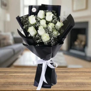 Pure Noir Bouquet featuring premium white roses and gypsophila in professional black floral gift wrapping.