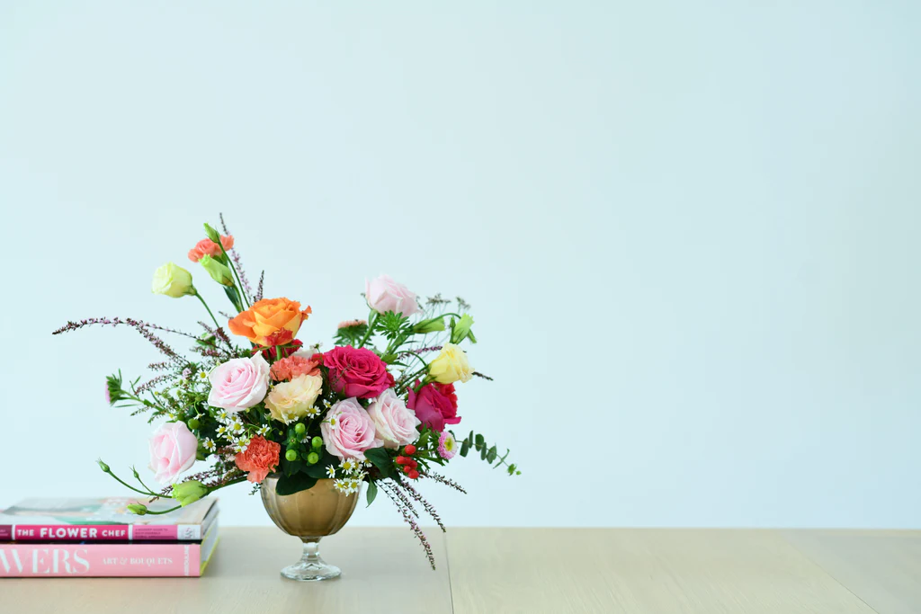 Elegant bouquet of Flowers in May featuring pink roses and gerberas in a gold vase